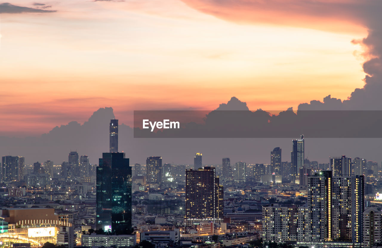 ILLUMINATED CITY AGAINST SKY DURING SUNSET