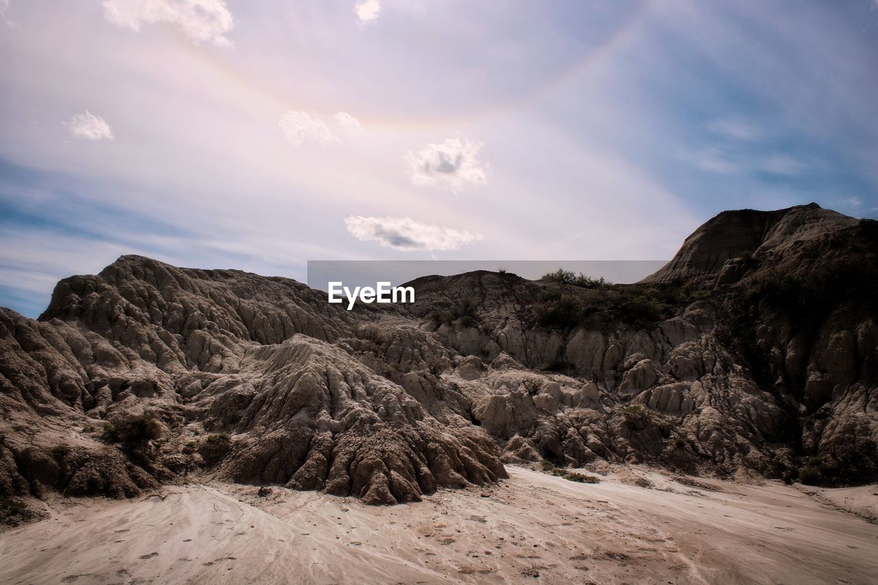 Scenic view of badland rock formations against sky