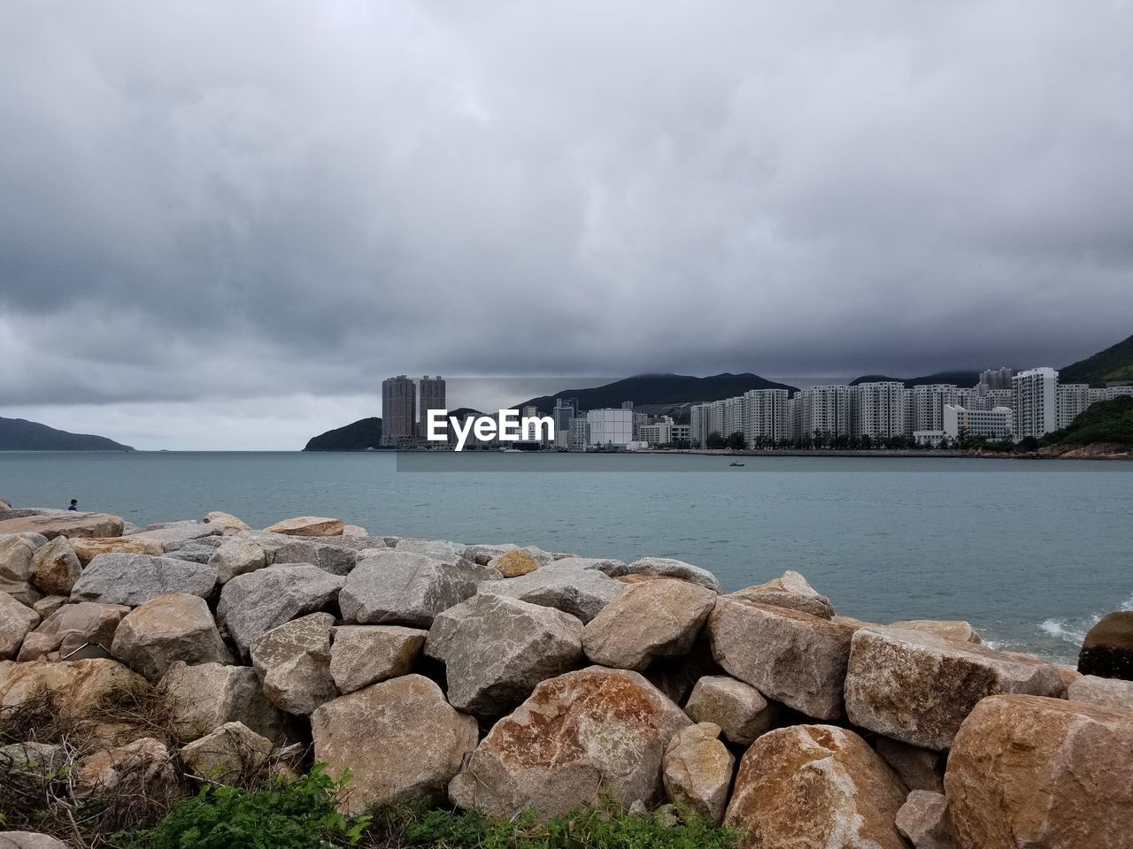 ROCKS IN SEA AGAINST SKY