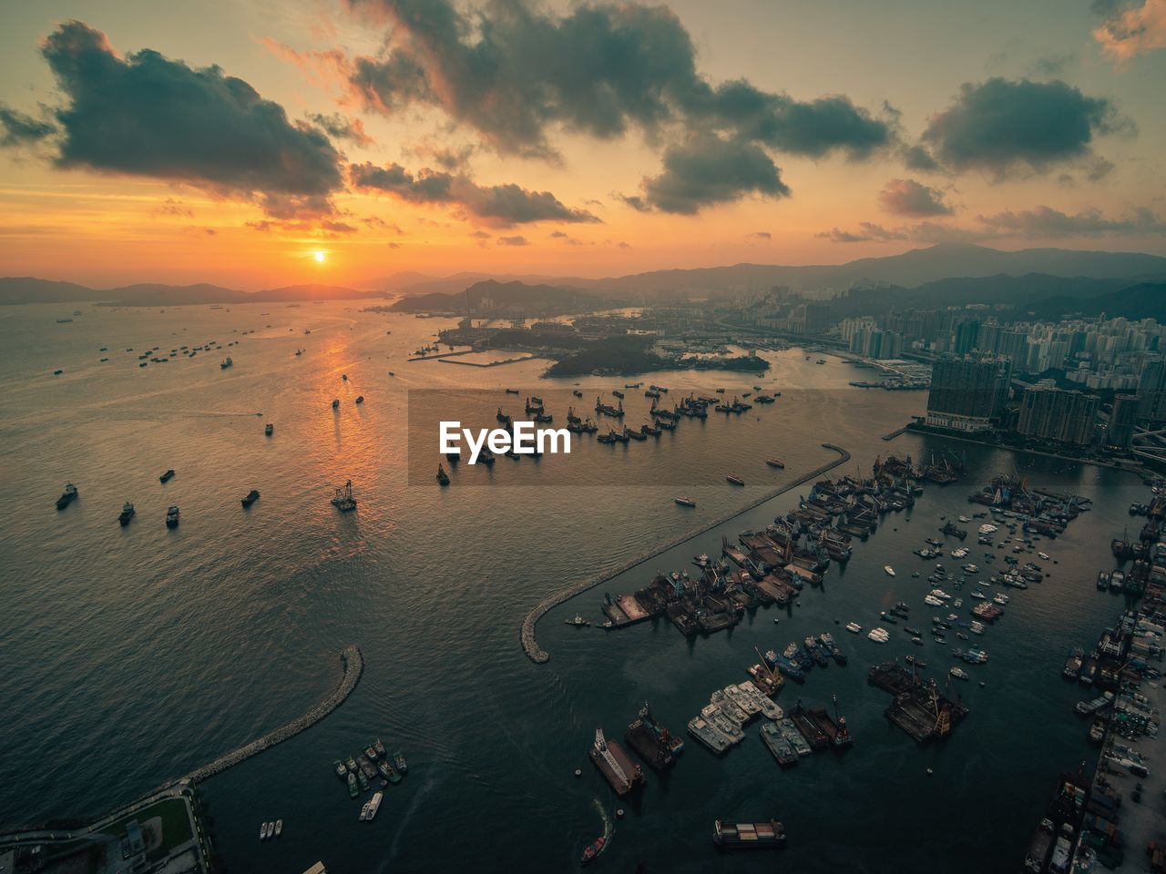 High angle view of hong kong city and bay against sky during sunset