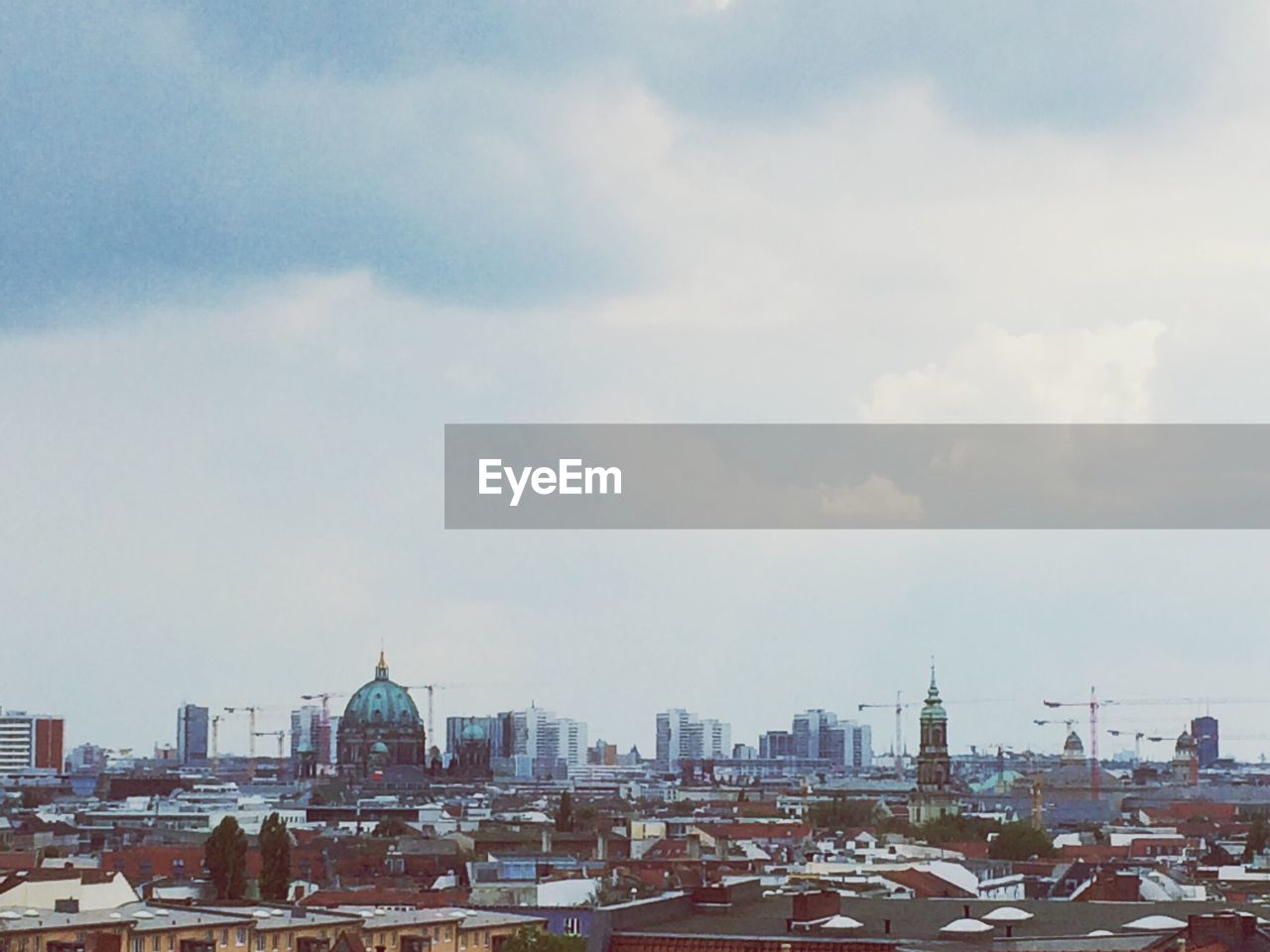 High angle view of city with cloud sky in background