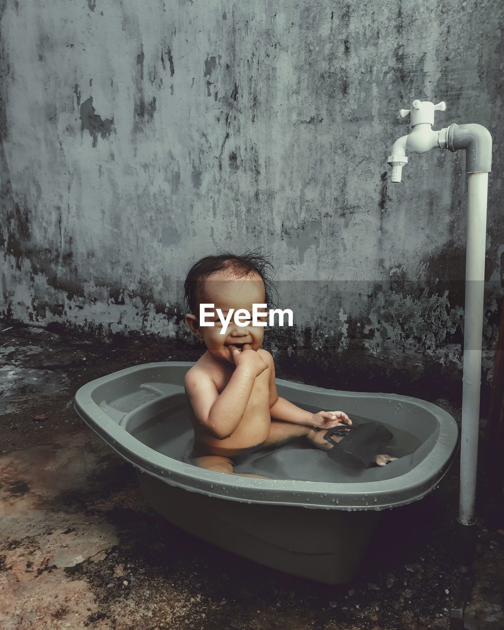 Portrait of shirtless boy in bathroom