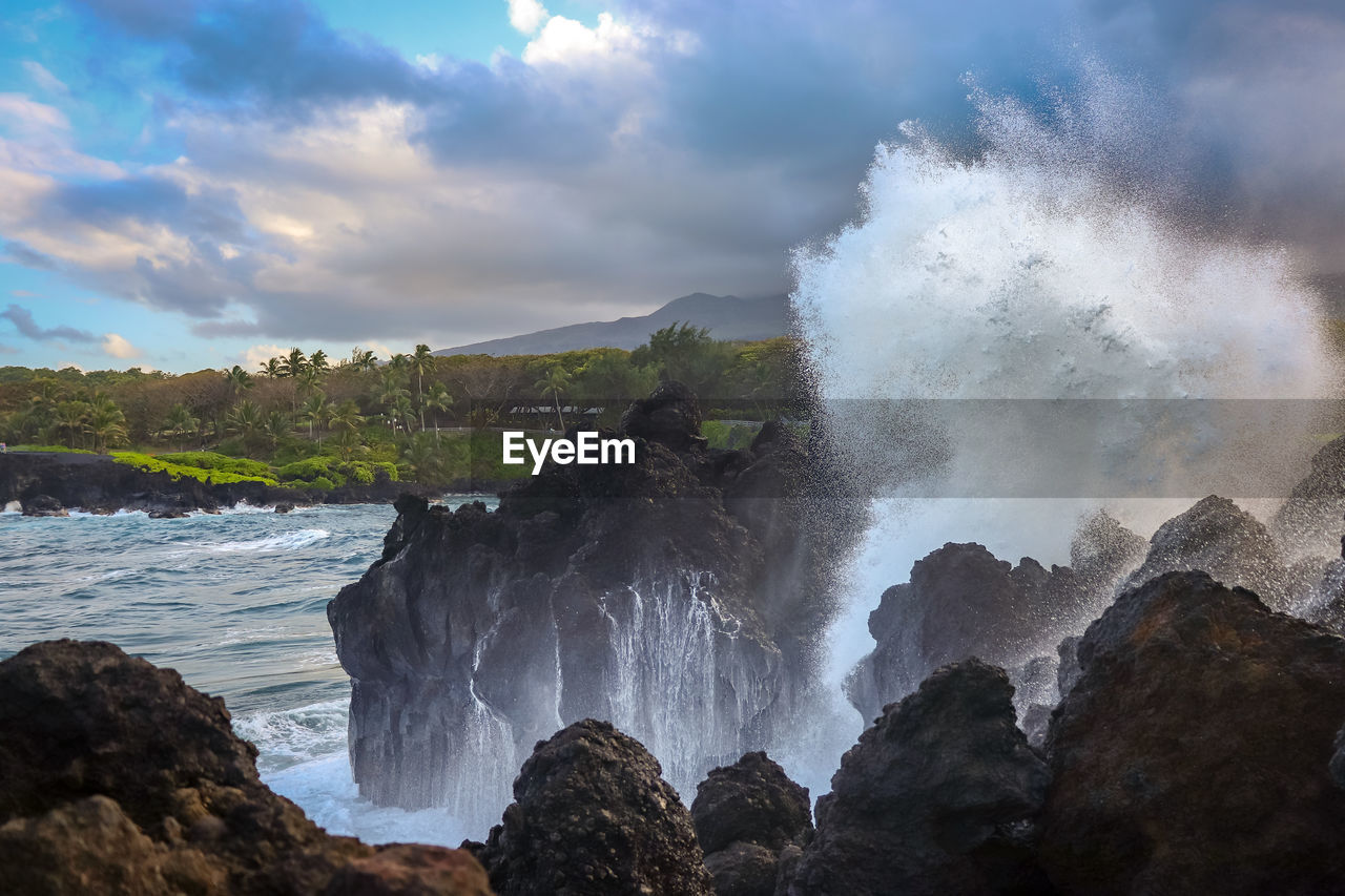 Scenic view of waterfall against sky