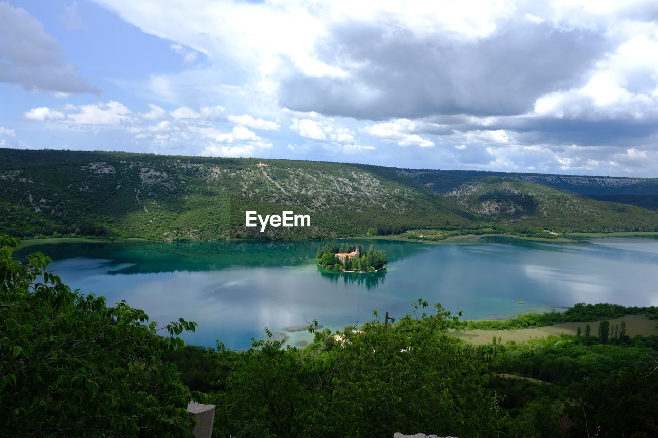 SCENIC VIEW OF LAKE AMIDST TREES AGAINST SKY