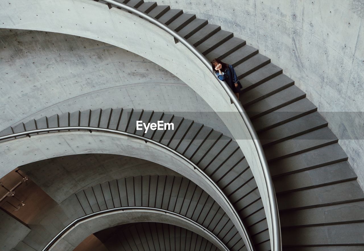 High angle view of woman on spiral staircase