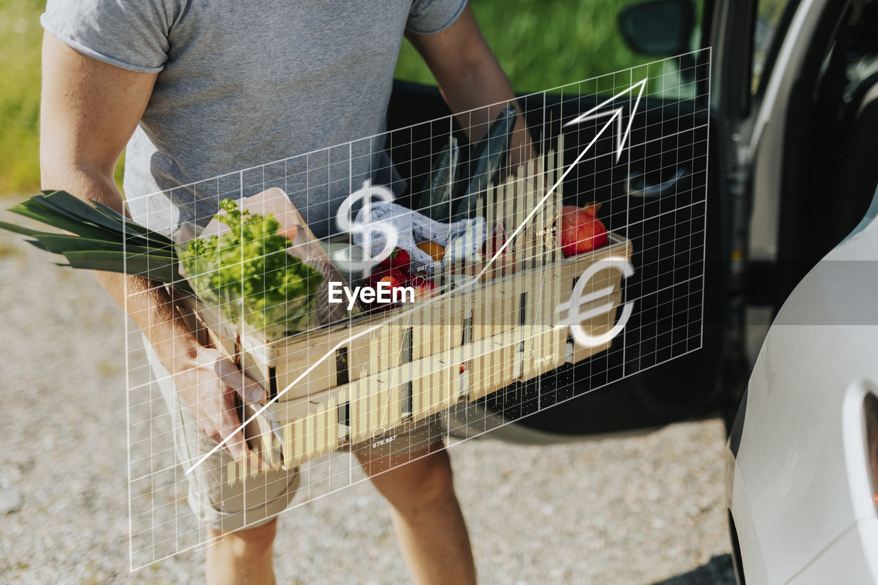 Financial chart and man carrying vegetables