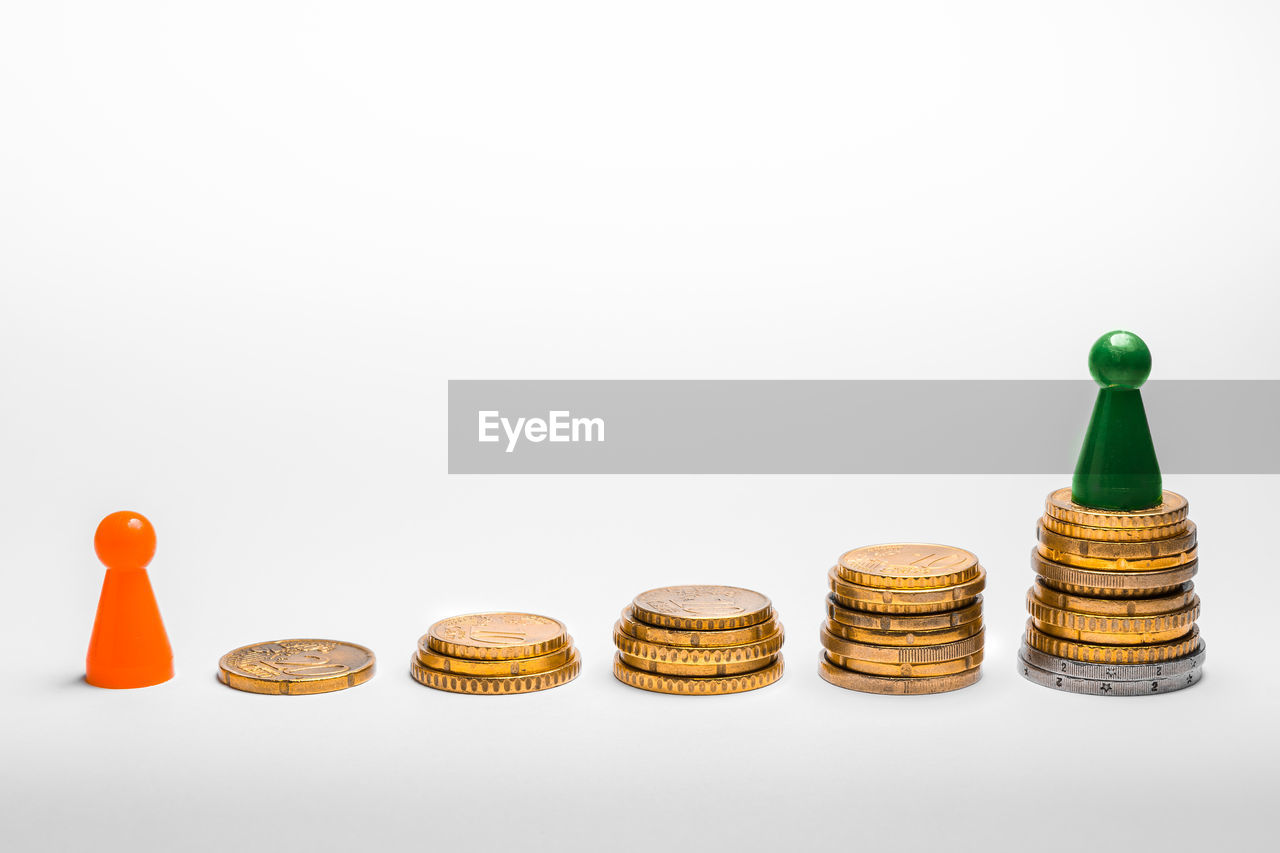 Stacked coins and token games on white background