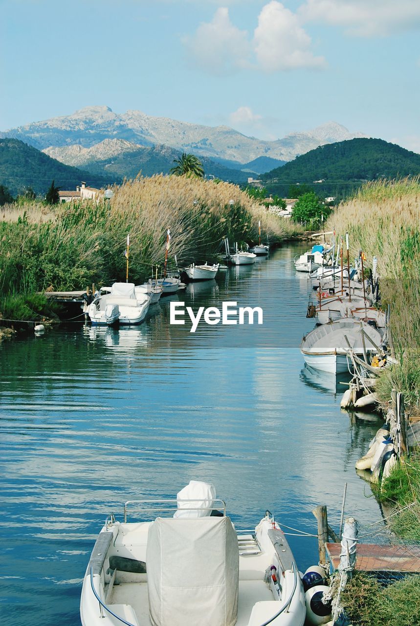 High angle view of boats moored in lake against sky