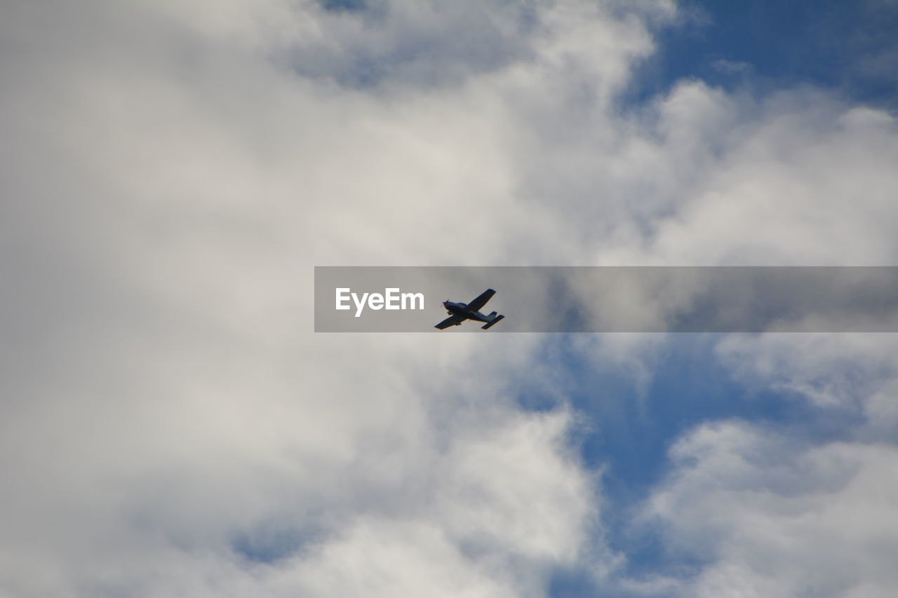 Low angle view of airplane against sky