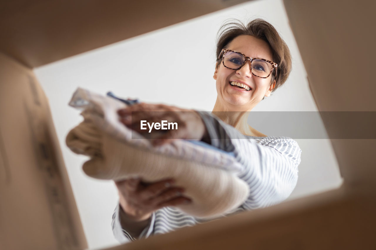 low angle view of young woman wearing sunglasses