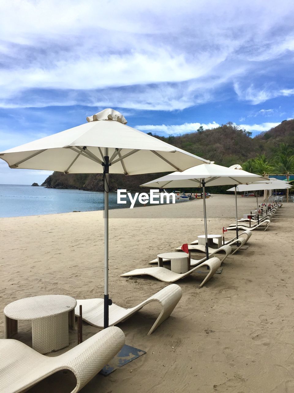 LOUNGE CHAIRS AND PARASOLS ON BEACH