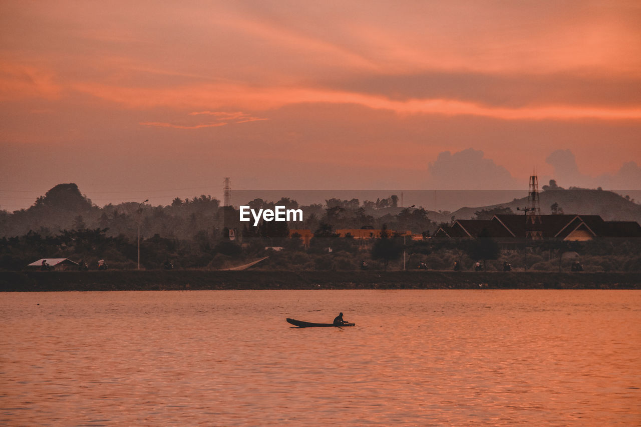 Scenic view of sea against orange sky