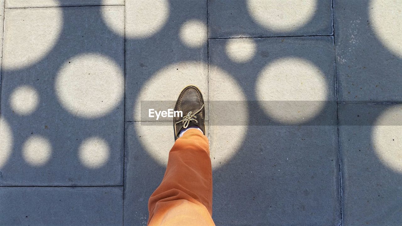 Human foot in spot light against sunlight