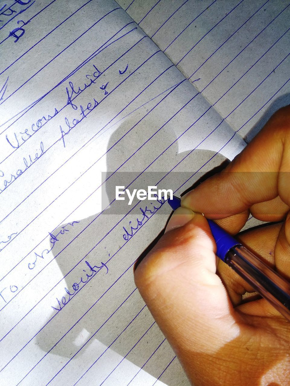 LOW SECTION OF MAN WITH TEXT ON PAPER