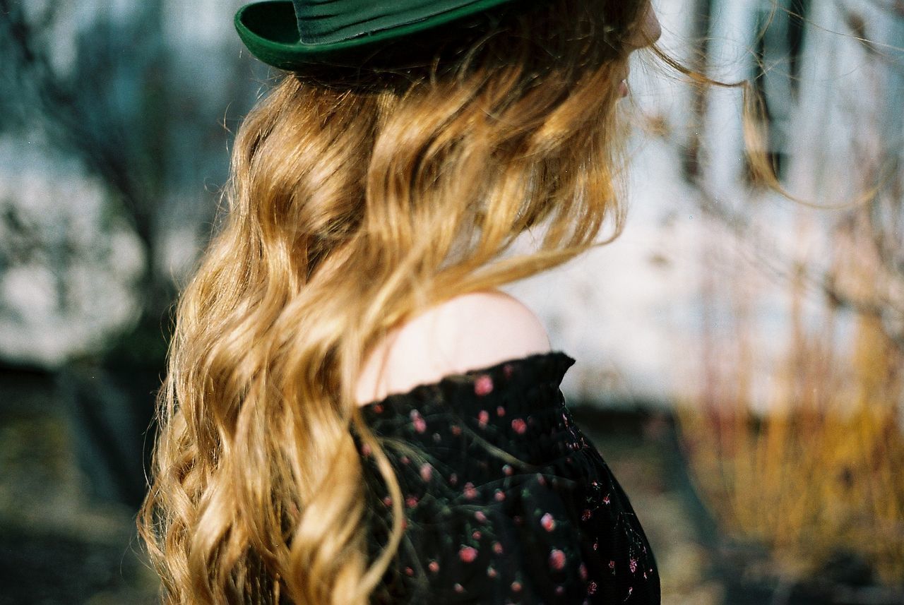 REAR VIEW OF WOMAN WITH LONG HAIR OUTDOORS