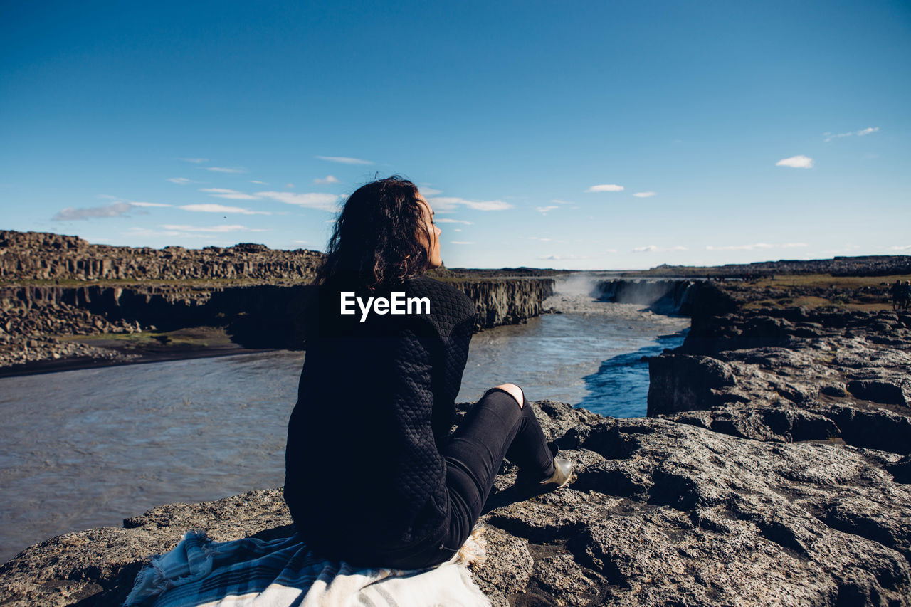 Rear view of woman overlooking river