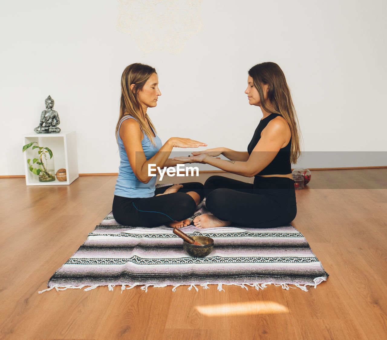 Two women doing reiki each other