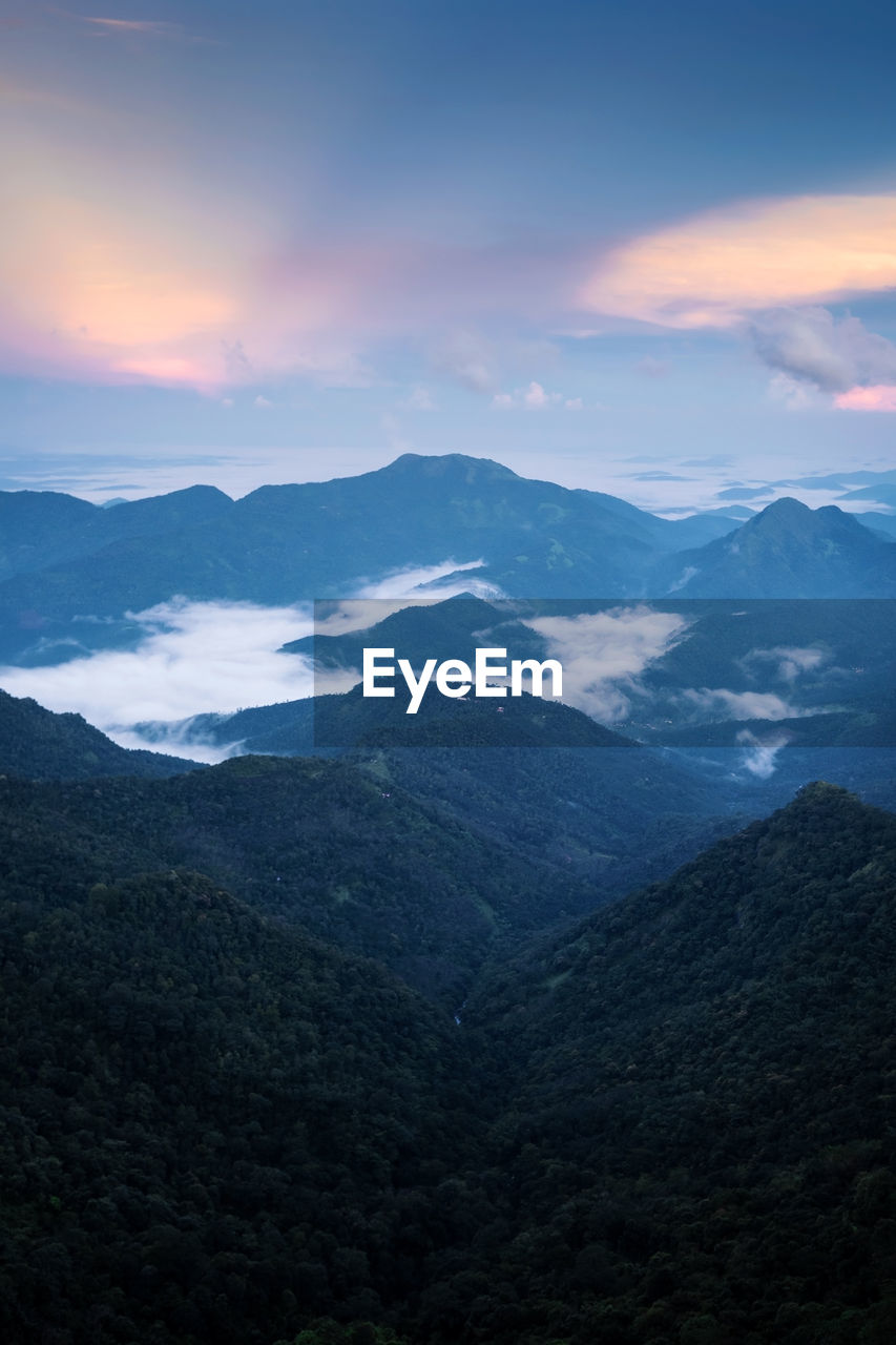 Scenic view of dramatic landscape against sky during sunset