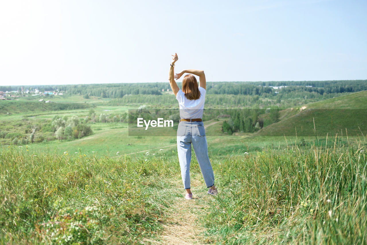 Field landscape, freedom and relax  concept, summer and spring. woman casual wear, enjoying travel. 