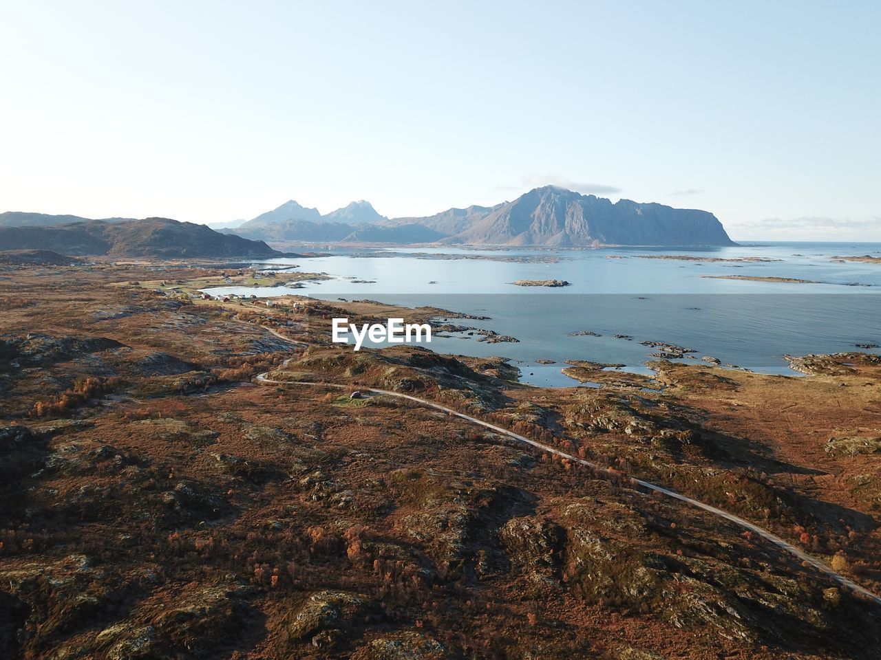 Aerial view of landscape and sea against clear sky