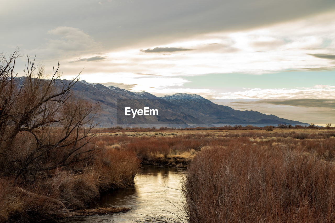 River in autumn valley view with distant mountains