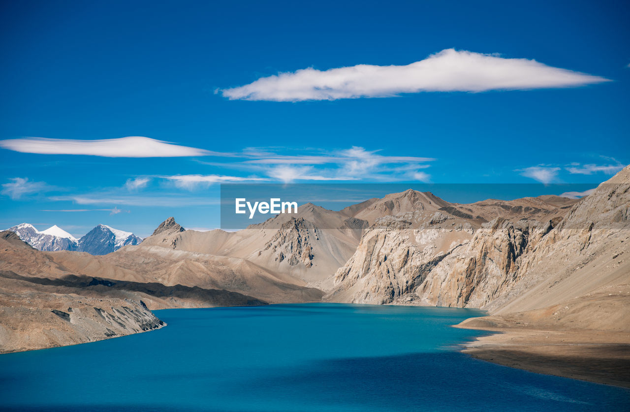 Scenic view of mountains against blue sky