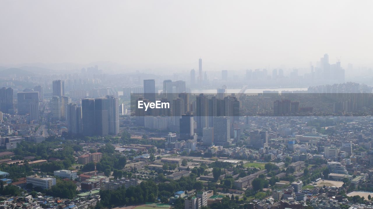 HIGH ANGLE VIEW OF CITY BUILDINGS AGAINST SKY