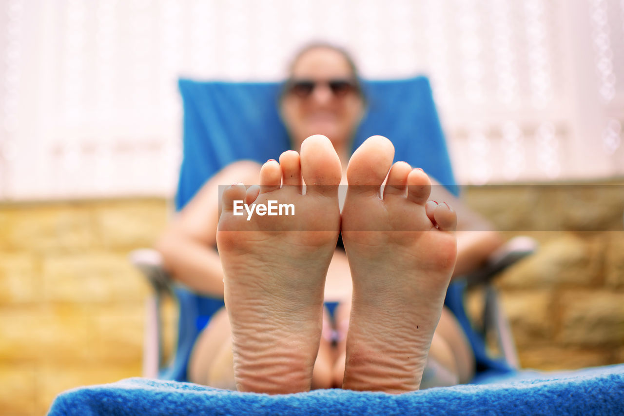 Low section of woman relaxing outdoors