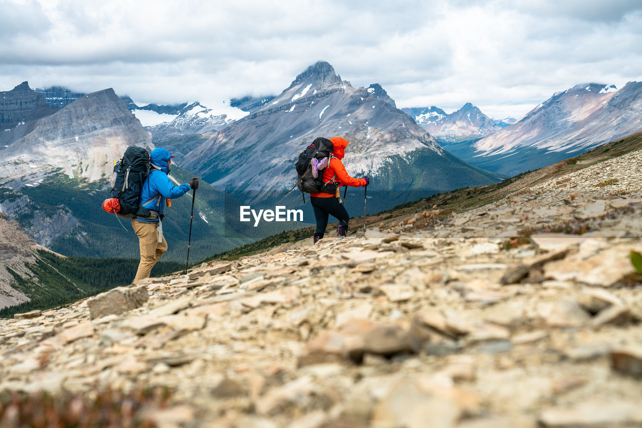 Couple hiking over an unnamed pass in banff national park