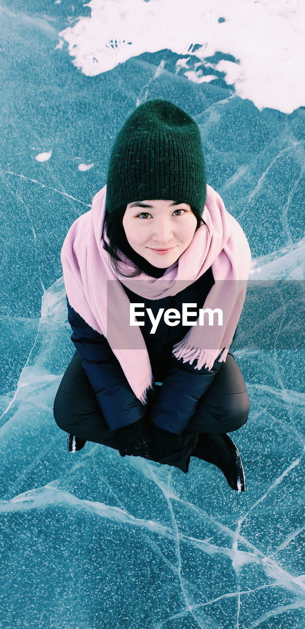 Portrait of young woman on a frozen lake 