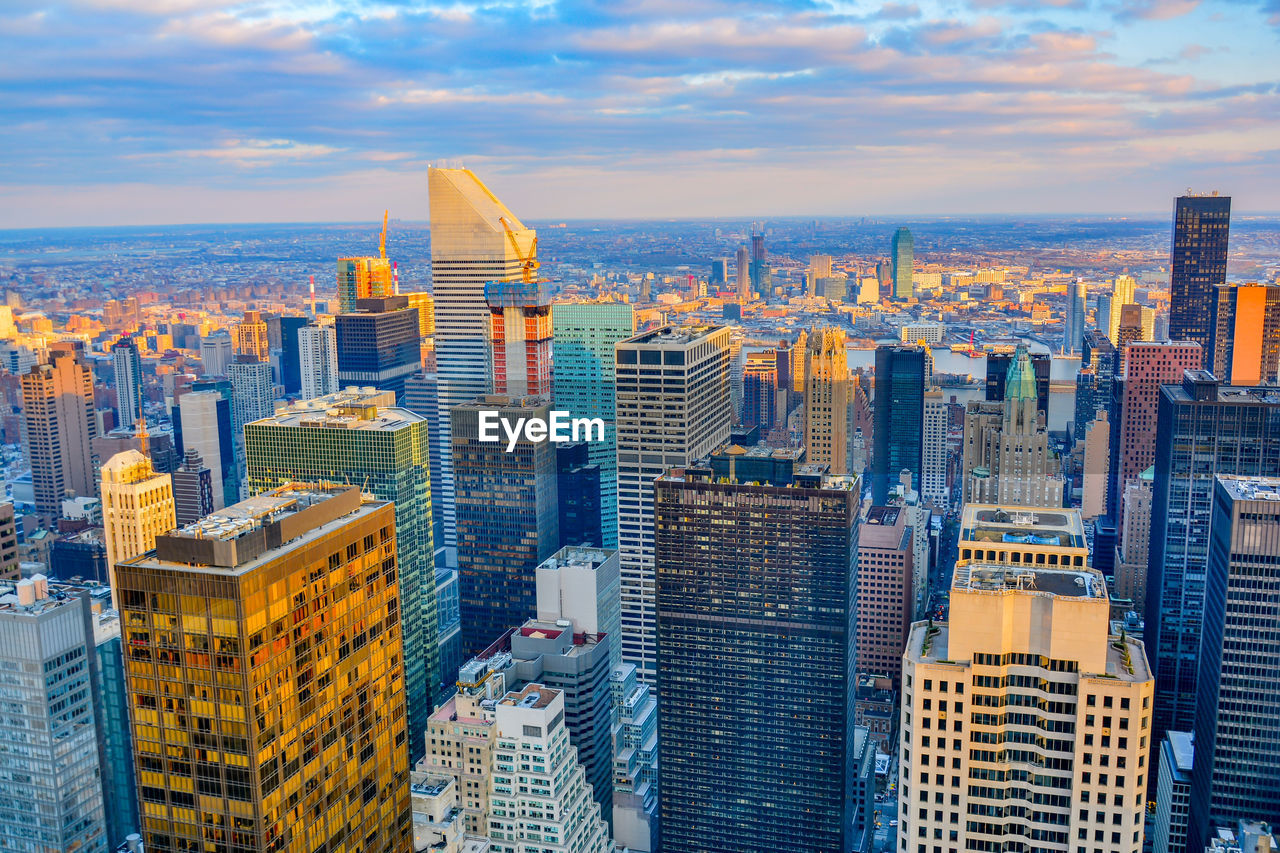 High angle view of cityscape against cloudy sky