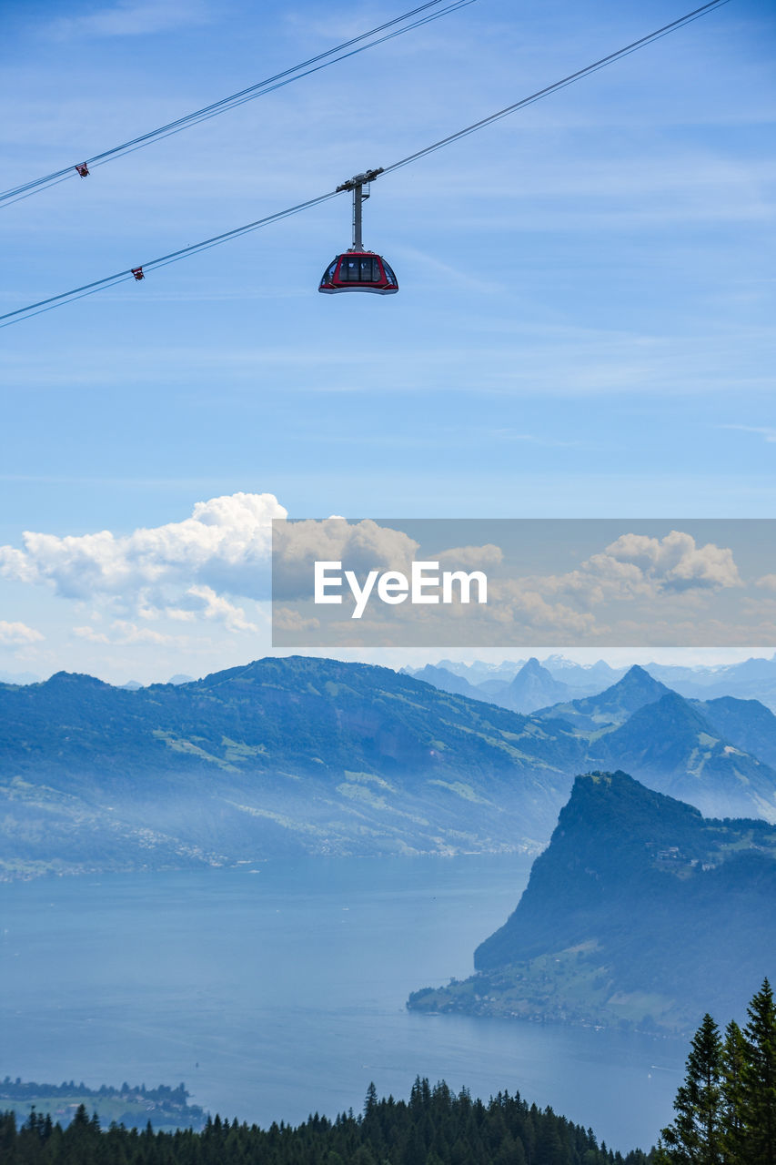 OVERHEAD CABLE CARS AGAINST MOUNTAINS