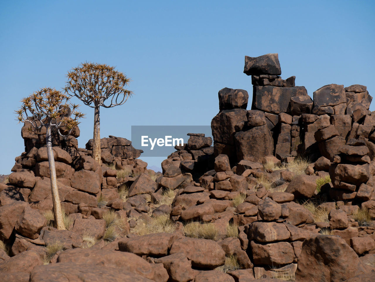 low angle view of rock formations against sky