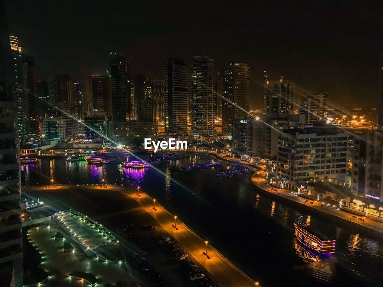 High angle view of city lit up at night