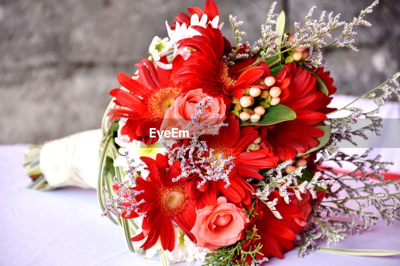 CLOSE-UP OF RED ROSES ON BOUQUET