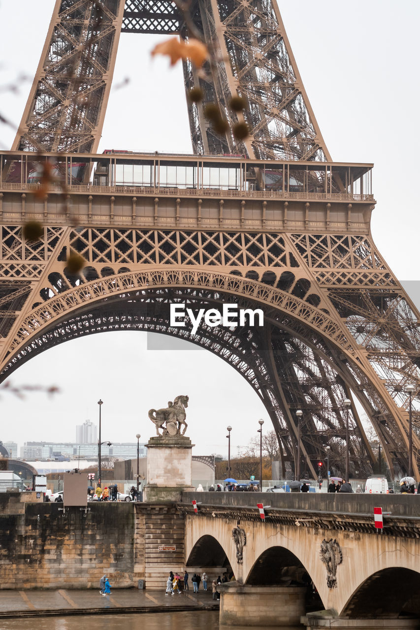 The pont d'iena over the seine river and the eiffel tower in autumn in the rain in paris - france