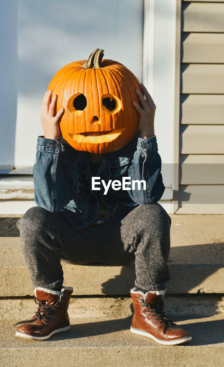 Low section of man with jack o lantern