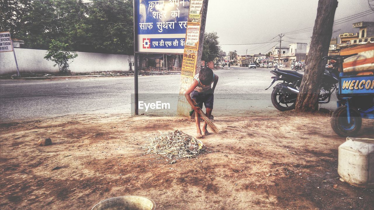 WOMAN WALKING ON ROAD IN CITY