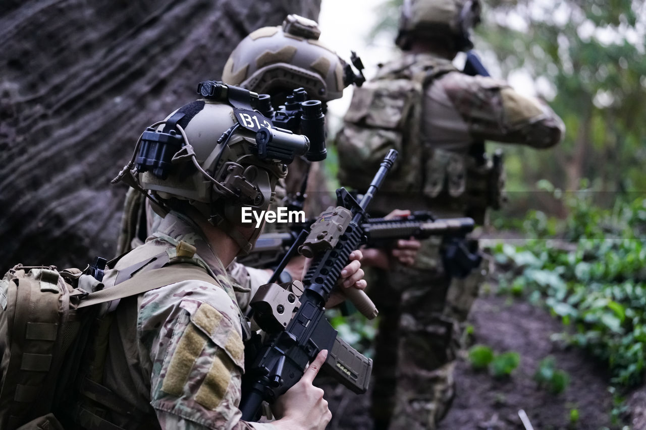 weapon, government, gun, military, armed forces, rifle, adult, conflict, soldier, army, aiming, uniform, security, fighting, game, clothing, military uniform, person, protection, camouflage clothing, war, headwear, holding, men, helmet, army helmet, outdoors, assault rifle, sports, machine gun