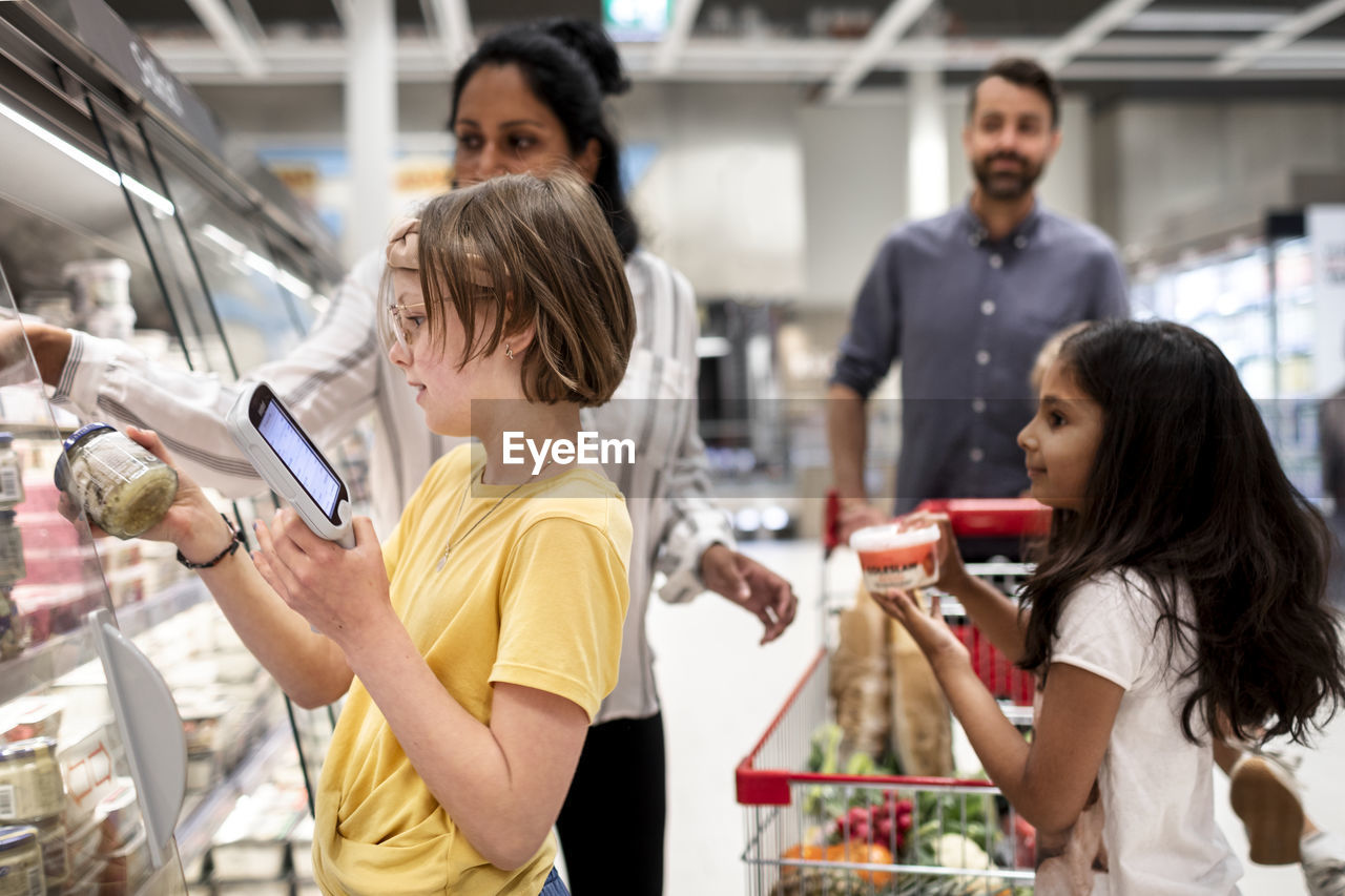 Family doing shopping in supermarket