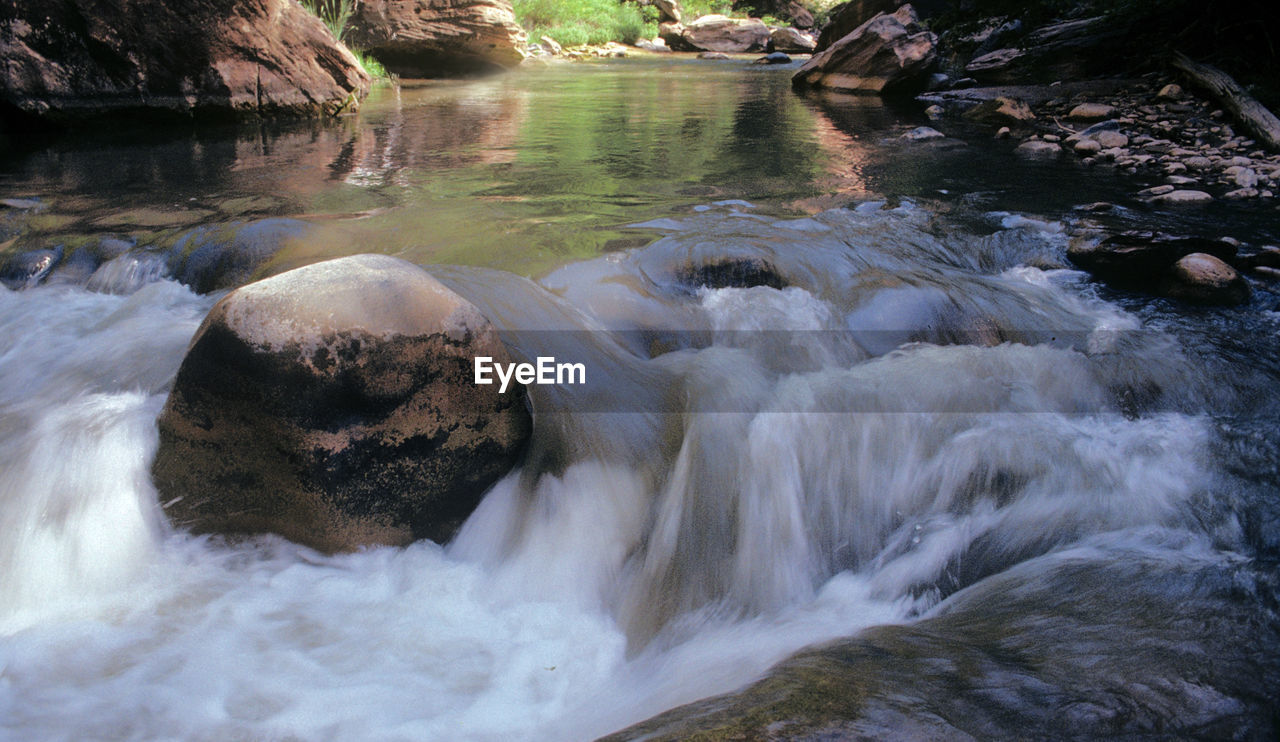 SCENIC VIEW OF RIVER FLOWING THROUGH ROCKS