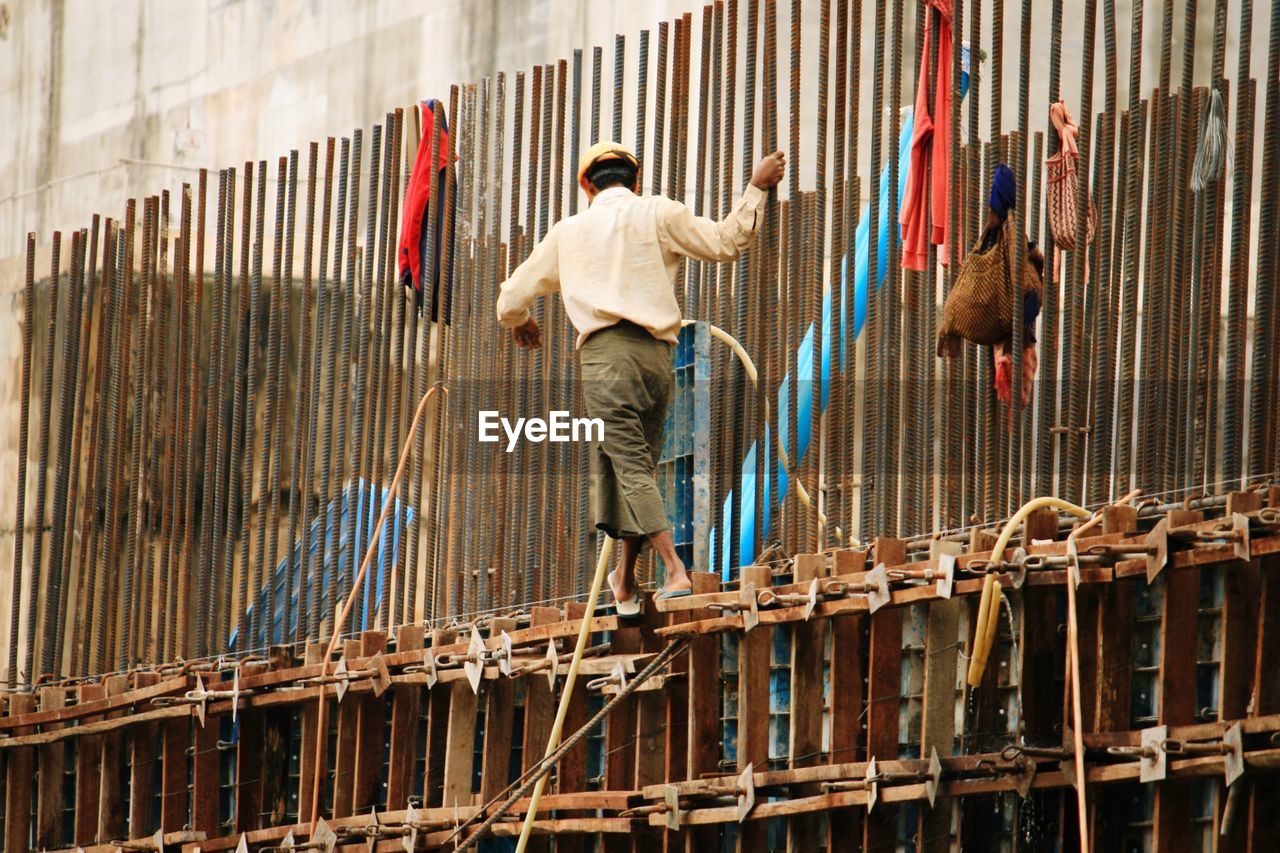 Rear view of man working at construction site