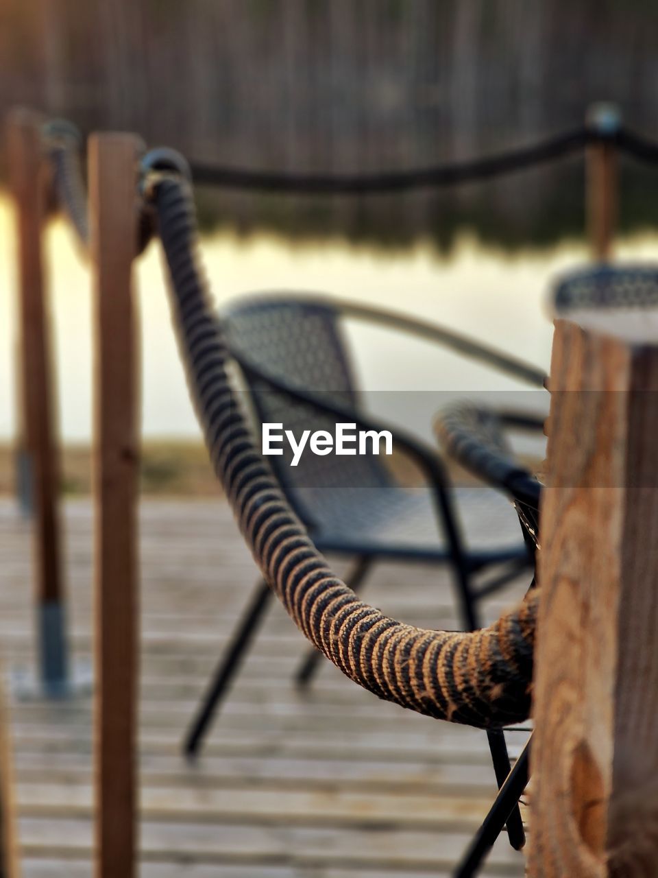 iron, wood, focus on foreground, no people, water, close-up, day, metal, rope, selective focus, nature, outdoors, railing