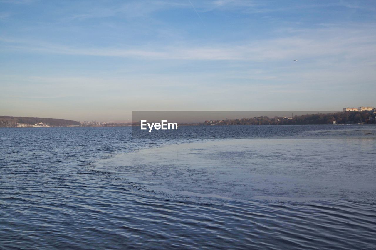 SCENIC VIEW OF SEA AGAINST SKY IN CITY