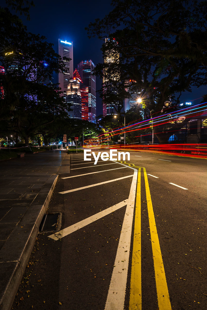 Light trails towards the city skyscrapers in singapore.