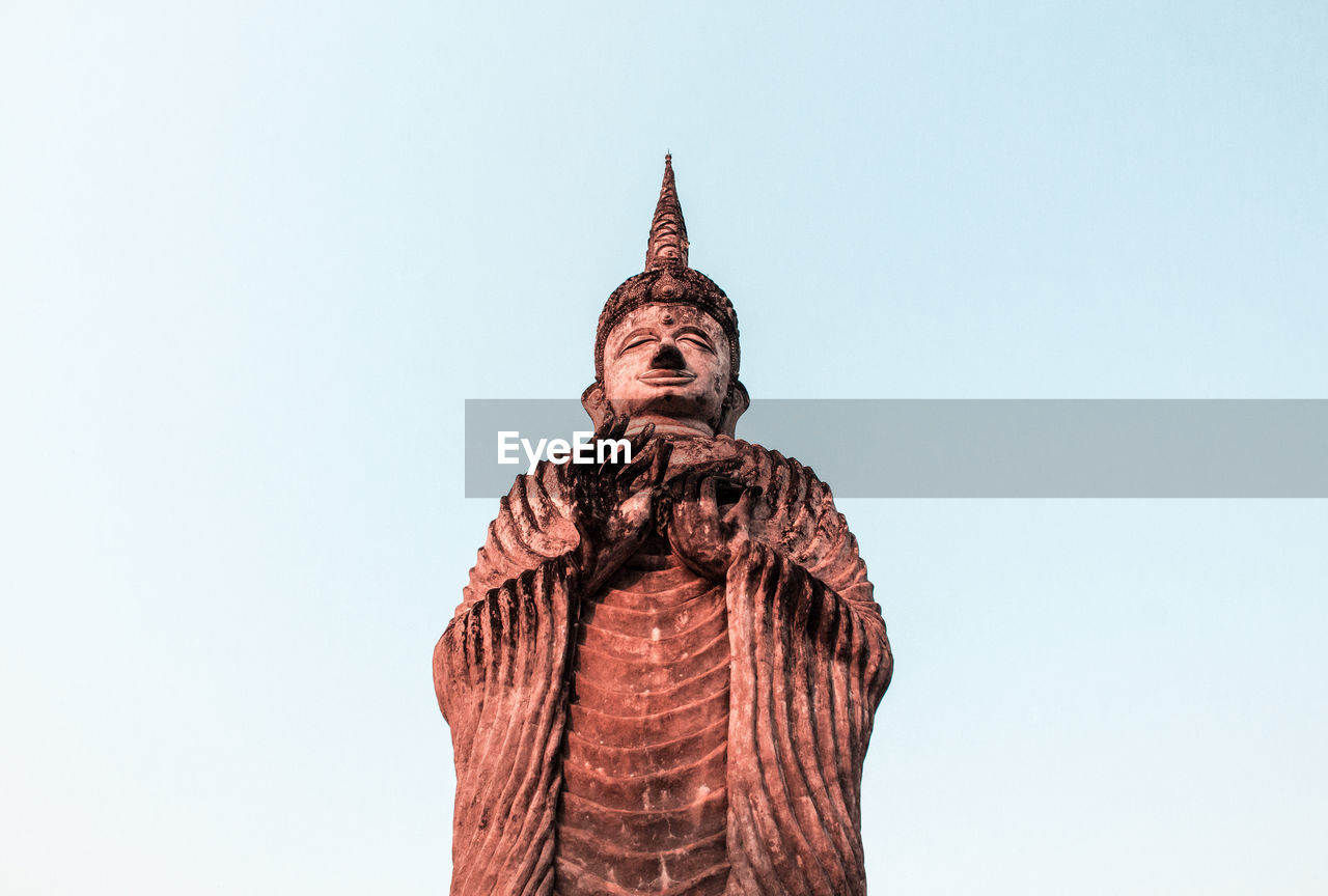 LOW ANGLE VIEW OF STATUE OF BUDDHA AGAINST SKY