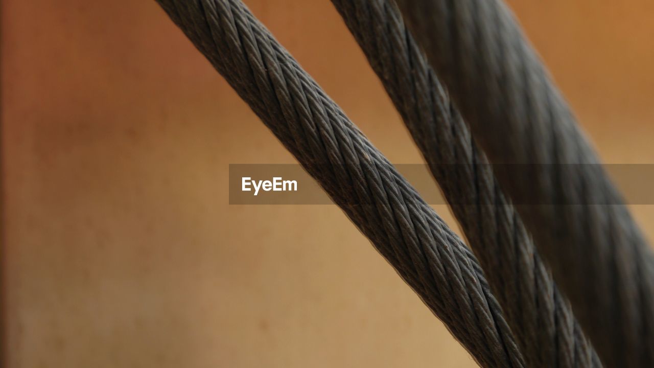 CLOSE-UP OF ROPE AGAINST METAL