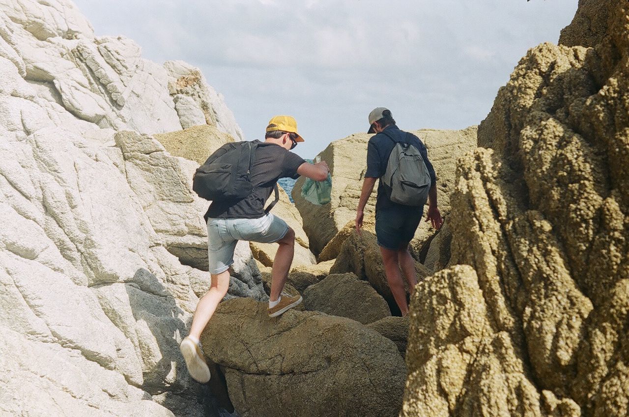 Rear view of woman standing on rocks