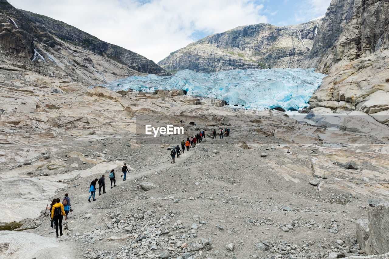 GROUP OF PEOPLE WALKING ON LANDSCAPE