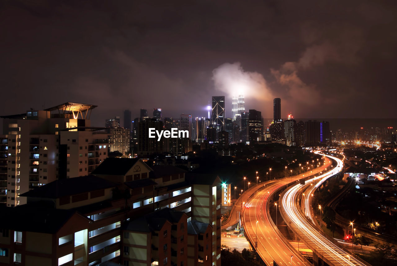 High angle shot of illuminated cityscape against sky at night